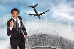 Composite image of happy businessman with fist