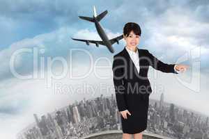 Composite image of smiling businesswoman pointing