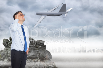 Composite image of thinking businessman tilting glasses