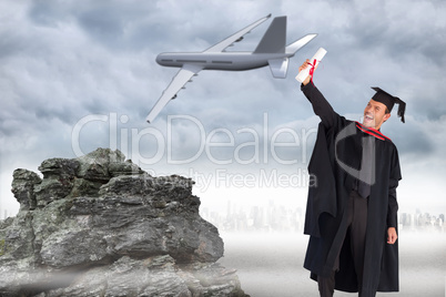 Composite image of delighted boy celebrating his graduation