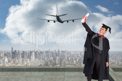 Composite image of delighted boy celebrating his graduation