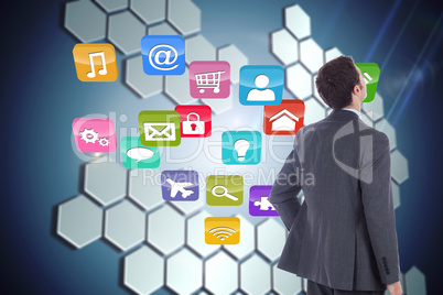 Composite image of businessman standing with hand on hip Composite image of businessman standing with hand on hip