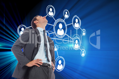 Composite image of cheerful businessman with hands on hips