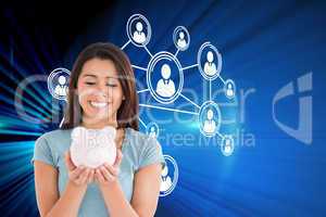 Composite image of attractive woman posing with a piggy bank