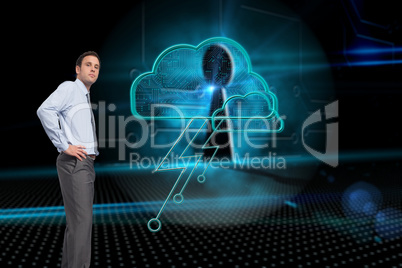 Composite image of serious businessman with hand on hip