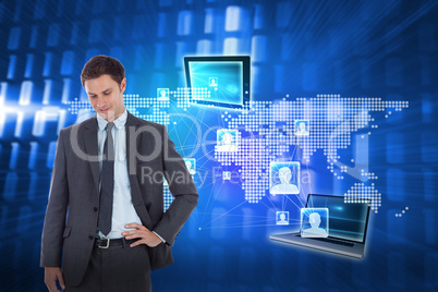 Composite image of smiling businessman with hand on hip