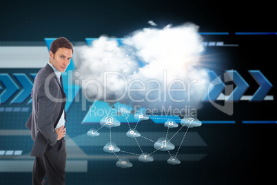 Composite image of serious businessman standing with hands on hi Composite image of serious businessman standing with hands on hi