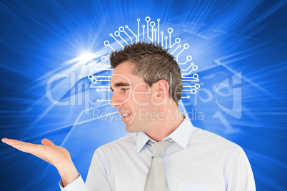 Composite image of smiling businessman looking at hand