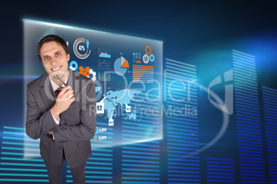 Composite image of thinking businessman holding pen