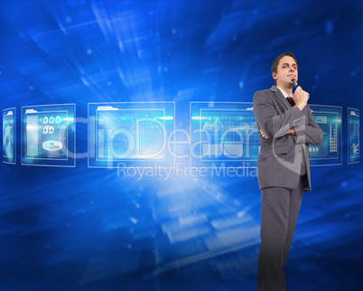 Composite image of thinking businessman holding glasses