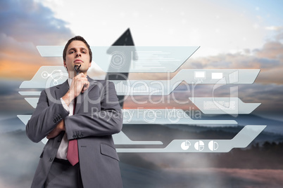 Composite image of thinking businessman holding his glasses