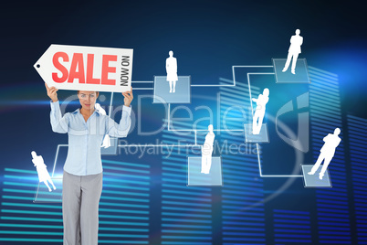 Composite image of businesswoman holding sign above her head