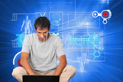 Composite image of bright man using a laptop