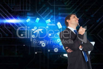 Composite image of thinking businessman holding pen