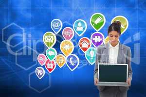 Composite image of businesswoman looking at laptop in her hands