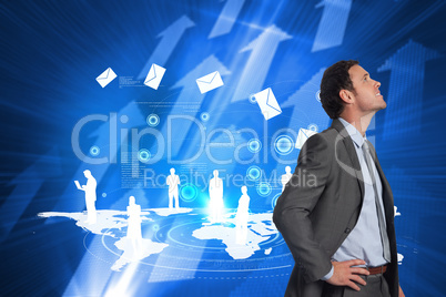 Composite image of smiling businessman with hand on hip