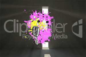 Composite image of microphone on paint splashes