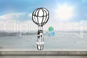 Composite image of girl in hot air balloon blowing earth bubbles