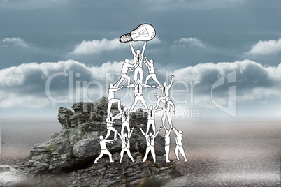 Composite image of team holding up light bulb