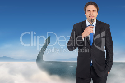 Composite image of thinking businessman holding glasses