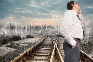 Composite image of thinking businessman touching his glasses