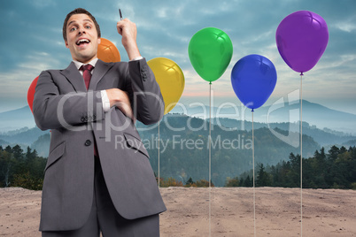 Composite image of thoughtful businessman holding pen