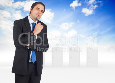 Composite image of thinking businessman holding pen