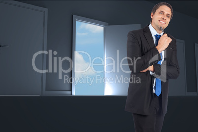 Composite image of thinking businessman holding pen