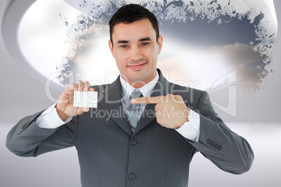 Composite image of businessman pointing at his businesscard