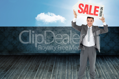 Composite image of businessman with sign above his head