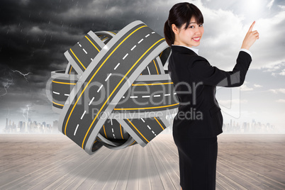 Composite image of smiling businesswoman pointing