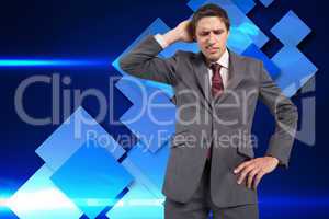 Composite image of thinking businessman scratching head