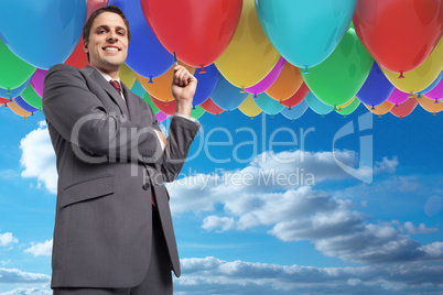 Composite image of thoughtful businessman holding pen