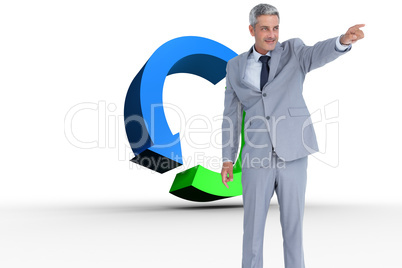 Composite image of handsome businessman pointing away