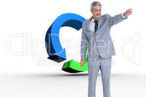 Composite image of handsome businessman pointing away
