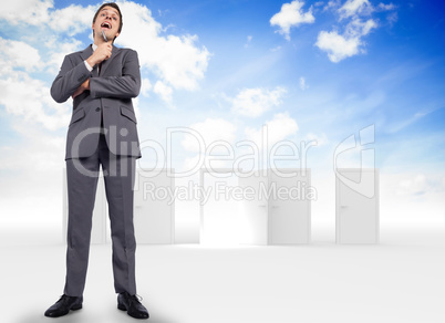 Composite image of thoughtful businessman holding pen to chin