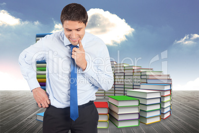 Composite image of thinking businessman touching his chin