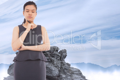 Composite image of thinking asian businesswoman