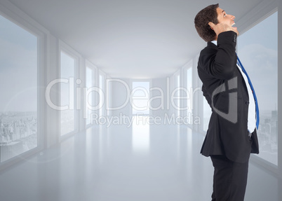 Composite image of thinking businessman scratching head