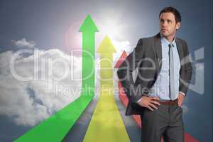 Composite image of serious businessman with hands on hips