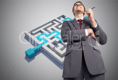 Composite image of thoughtful businessman holding pen