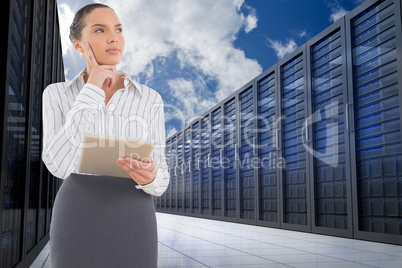 Composite image of confused businesswoman using a tablet pc