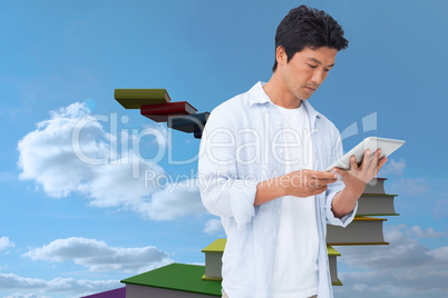 Composite image of male looking at his tablet computer