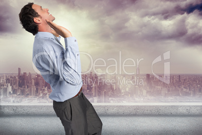 Composite image of businessman standing with arms pushing up