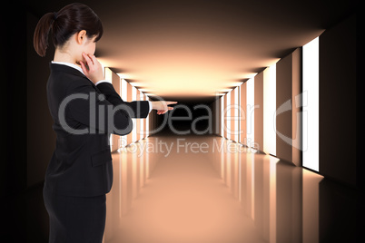 Composite image of thoughtful businesswoman pointing