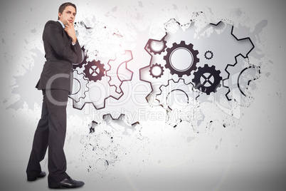 Composite image of thinking businessman touching chin