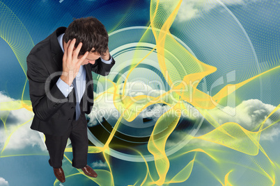 Composite image of stressed businessman with hands on head