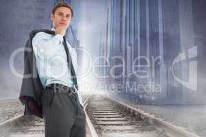 Composite image of serious businessman holding his jacket