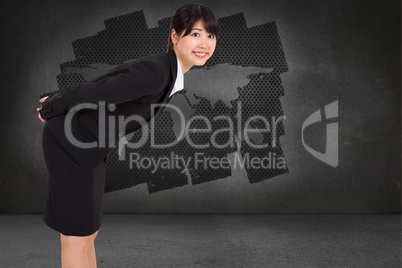 Composite image of smiling businesswoman bending