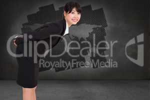 Composite image of smiling businesswoman bending